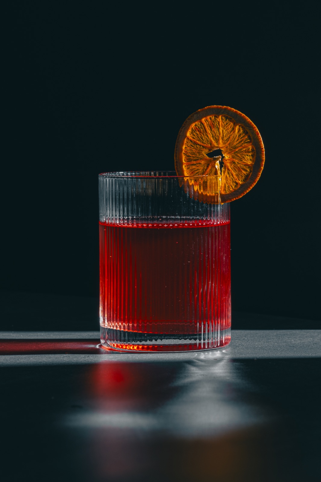 Front view of the red cocktail and backlit orange
